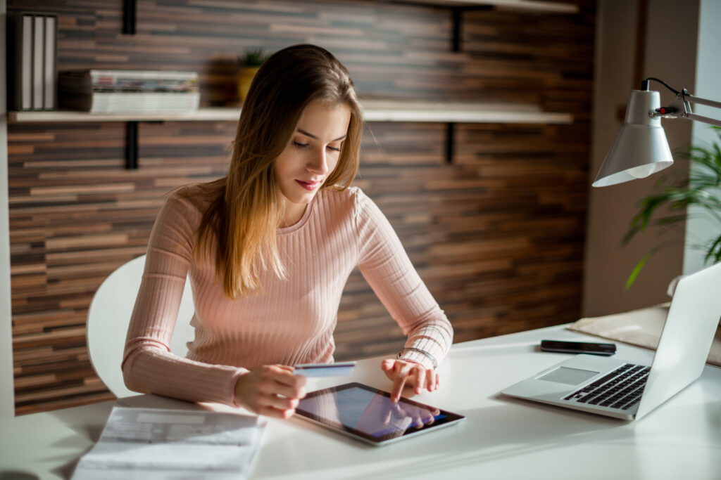 Businessperson checking her business credit score on her tablet.