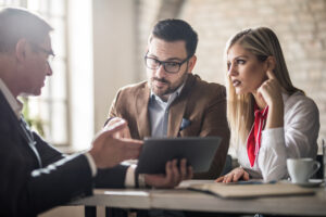 Business owners looking over their loan options with a financial advisor.