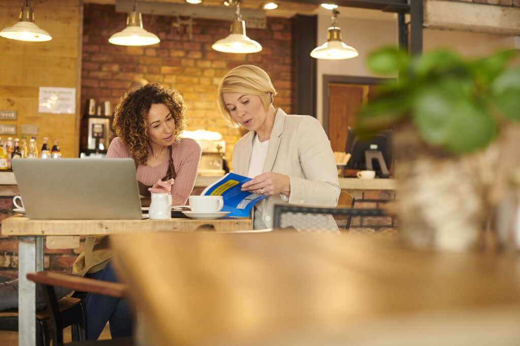 Feature image of two women talking at a restaurant