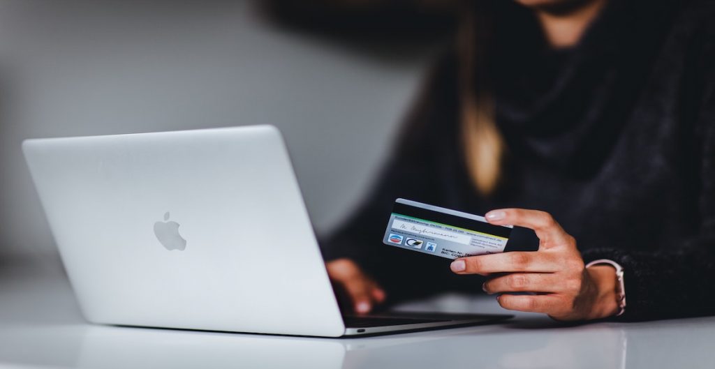 woman entering credit card information into a computer