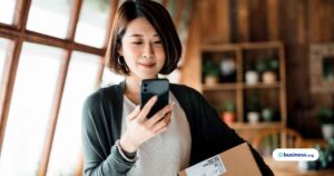 woman-using-phone-to-ship-for-small-business