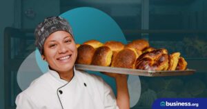 women baker holding bread rolls with abstract background